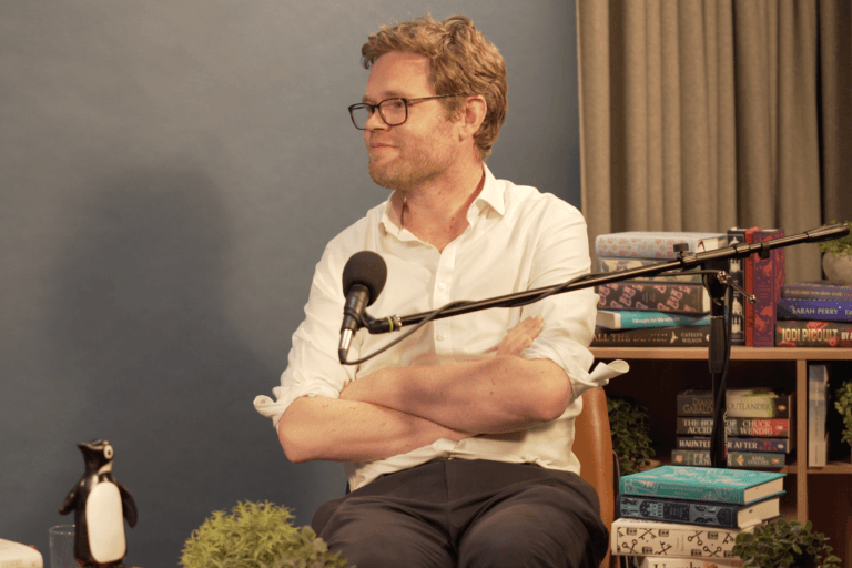 Author Henry Eliot seated in The Penguin Podcast Studio